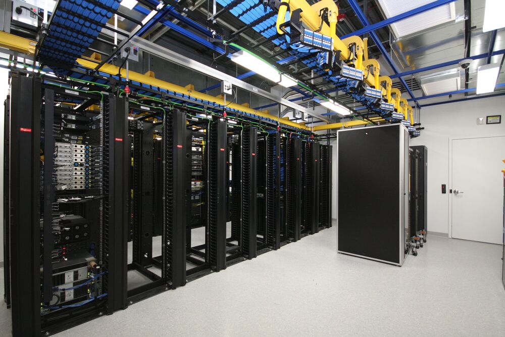Colocation cabinets with structured blue cabling in overhead tray