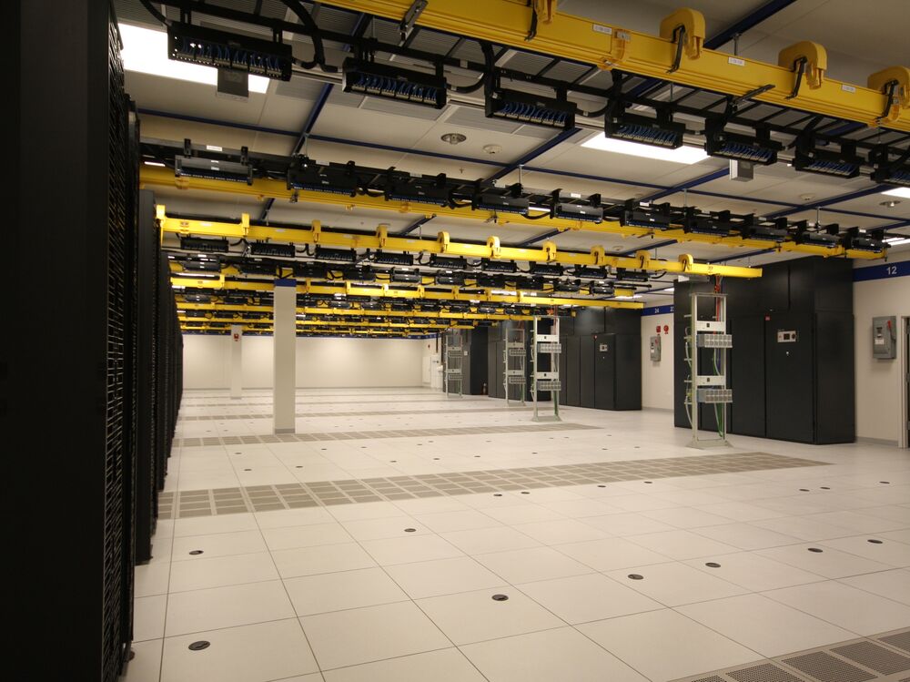 Phased data hall with cabinet rows and overhead cable tray
