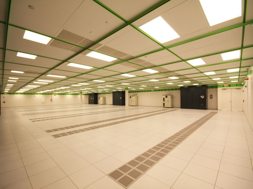Large open raised-floor data hall in a converted building